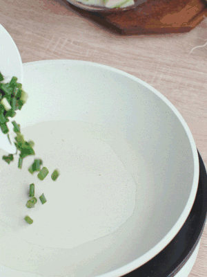 熱油下臘肉、蔥花煸炒，再下西葫蘆。